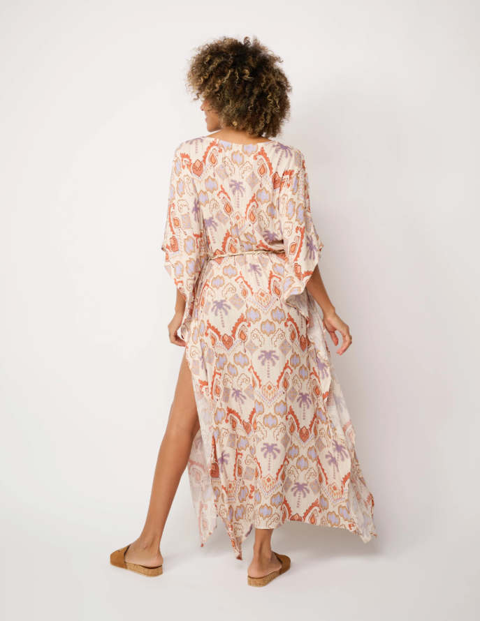  The dress is predominantly in shades of orange, white, and beige STMT BOUTIQUE 