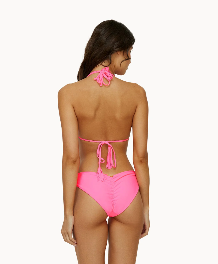 , a stylish and vibrant pink bikini top from the PQ swimwear collection STMT BOUTIQUE 
