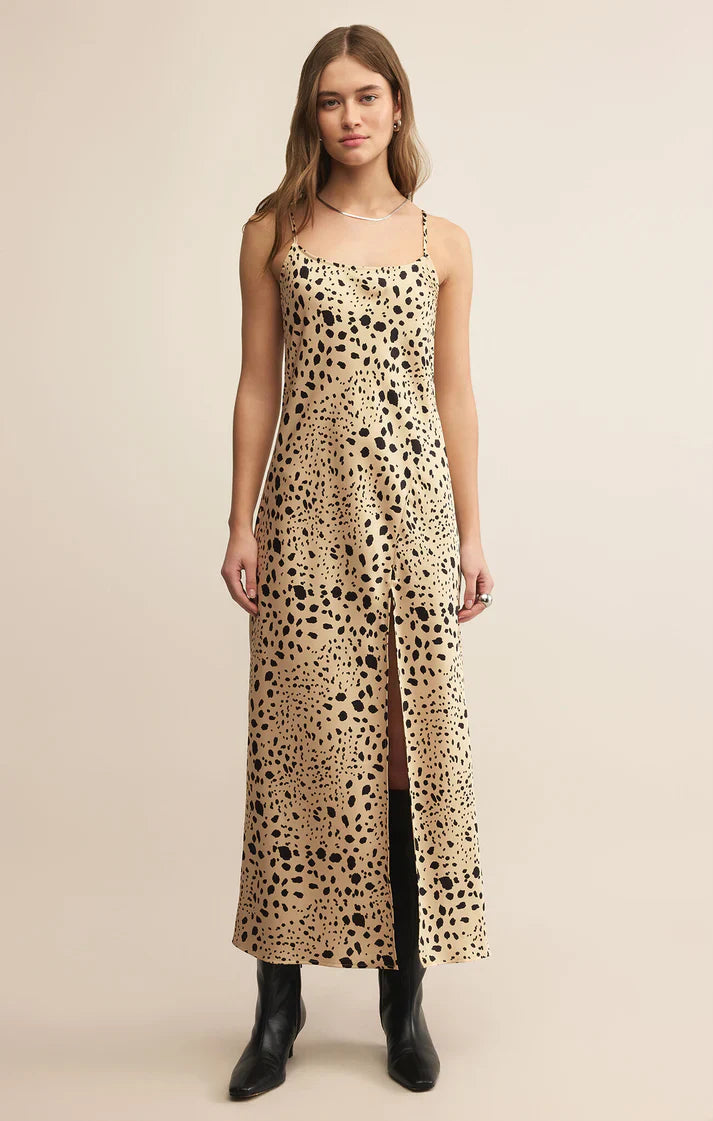Woman wearing a leopard print dress on a beige background