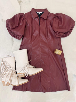 Maroon dress with puff sleeves and white boots on a light background