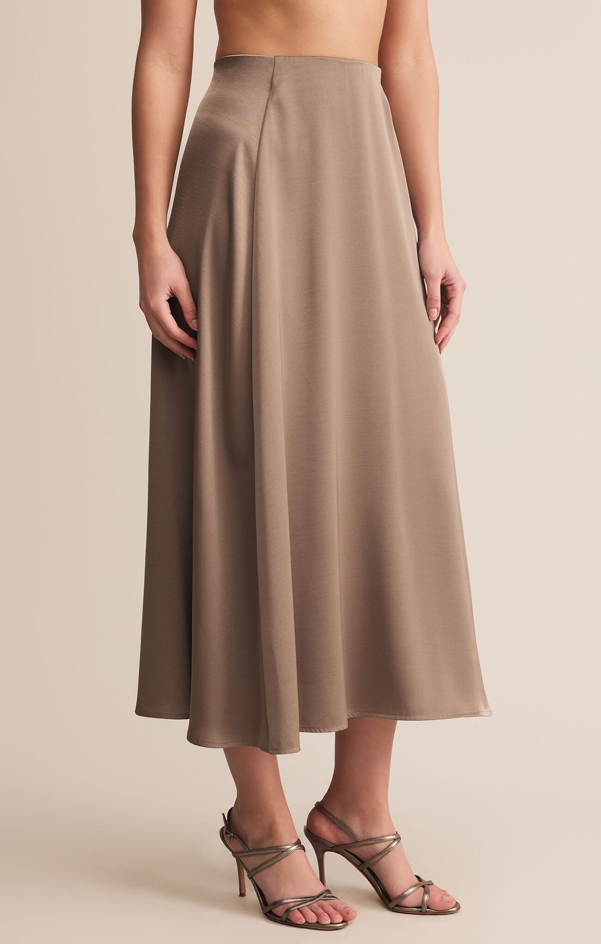Brown skirt worn by a person on a beige background