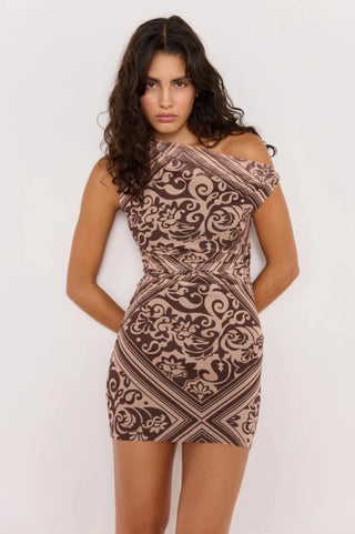 Woman wearing a patterned dress on a white background