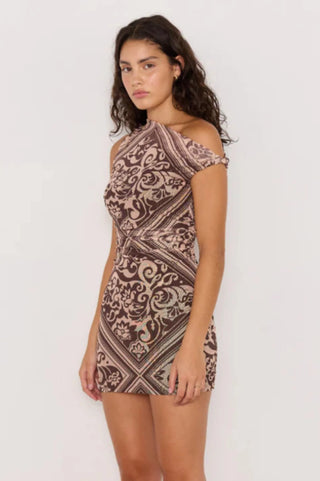 Woman wearing a patterned dress on a white background