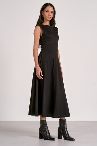 Woman wearing a black sleeveless dress with a white background