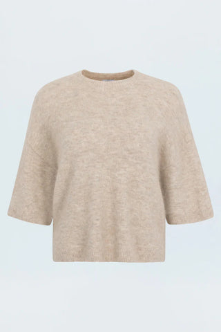 Beige sweater on a light blue background