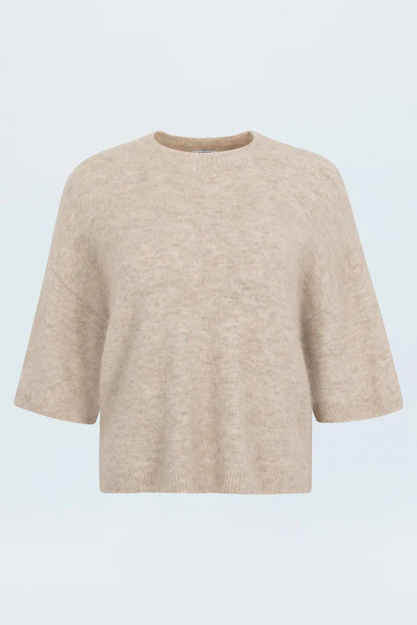 Beige sweater on a light blue background