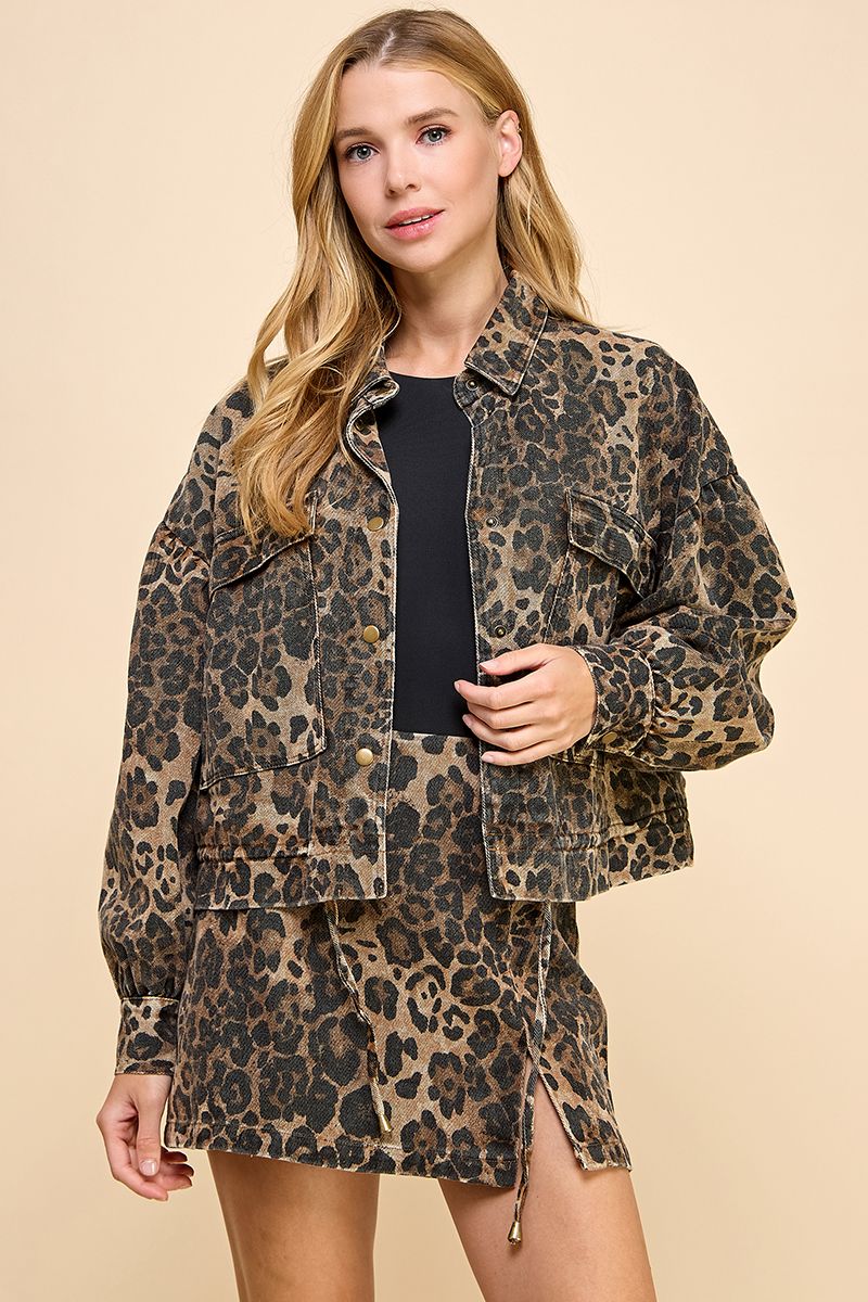 Woman wearing a leopard print jacket and skirt set on a beige background