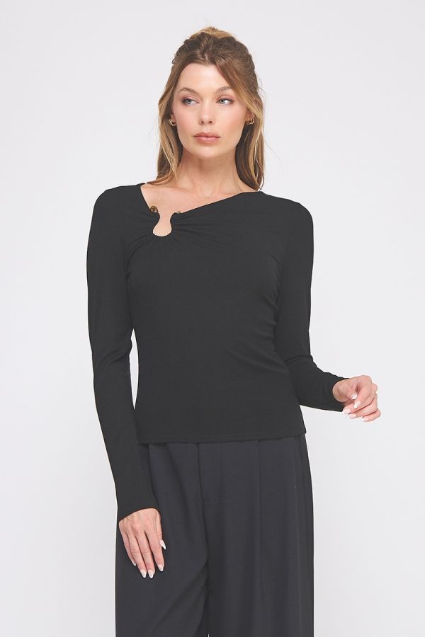 Woman wearing a black long-sleeve top and black pants on a white background