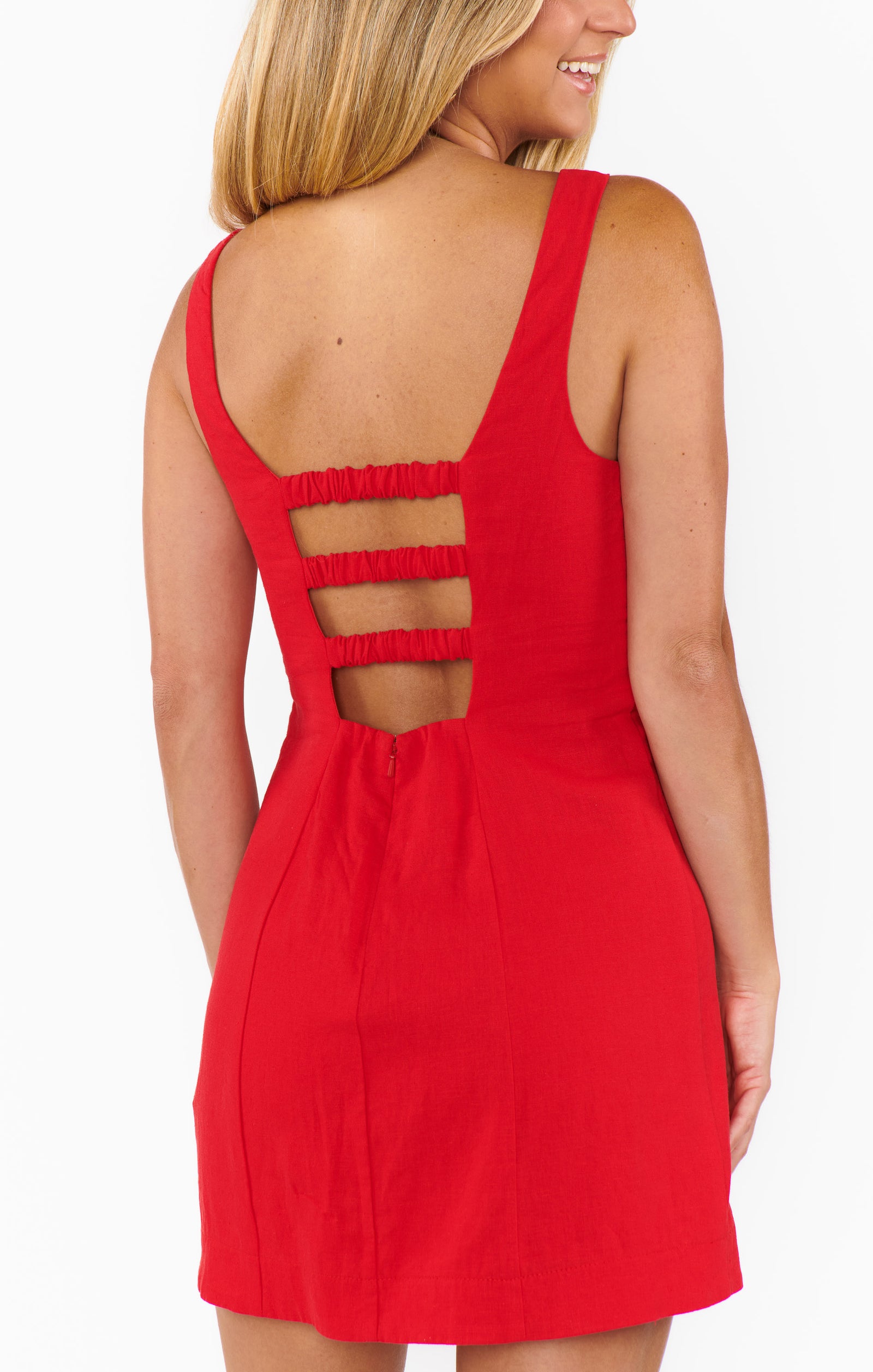 Red dress with open back design worn by a person on a white background.