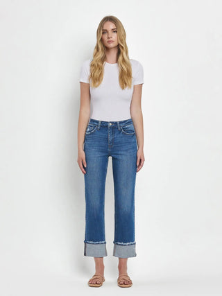 Woman wearing blue jeans and a white t-shirt on a white background