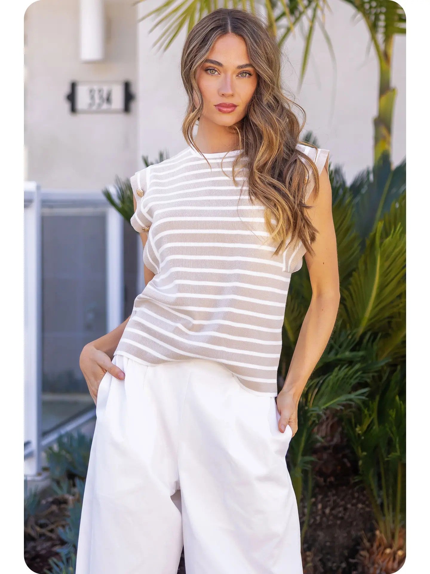 Elegant layering with striped sleeveless knit top under blazer