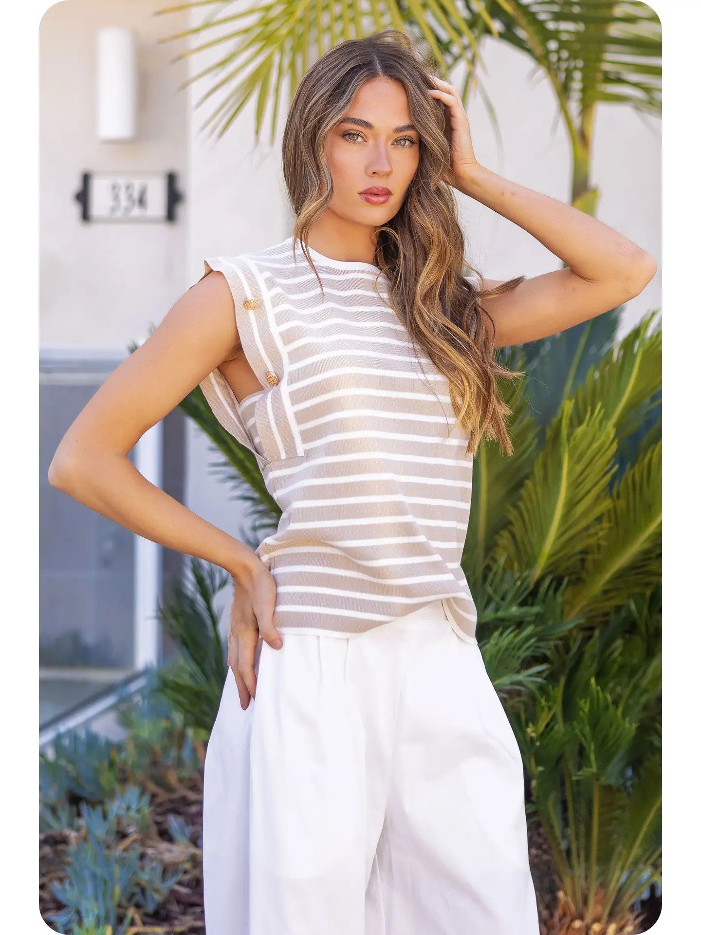 Elegant layering with striped sleeveless knit top under blazer