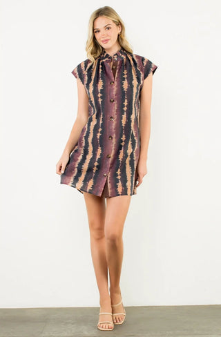 Woman wearing a patterned dress on a white background