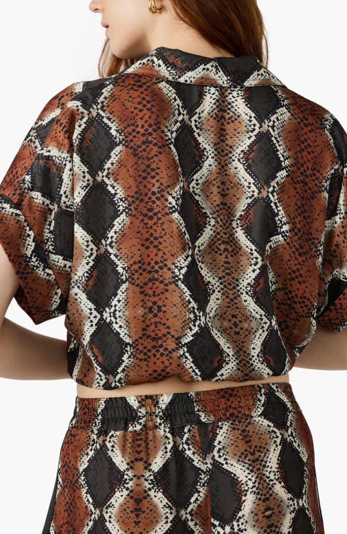 Woman wearing a patterned outfit with a white background