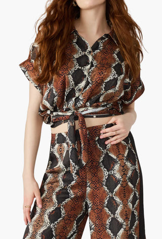 Woman wearing a patterned outfit with a white background