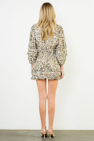 Woman wearing a patterned dress against a white background