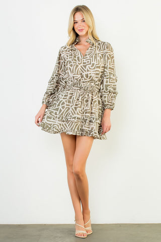 Woman wearing a patterned dress against a white background