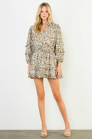 Woman wearing a patterned dress against a white background