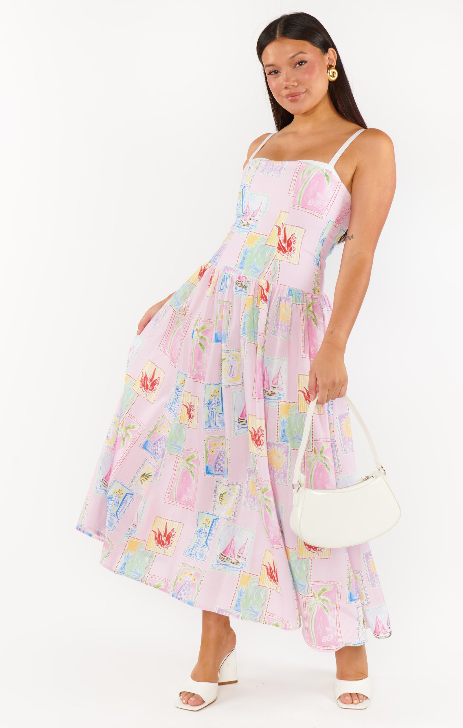 wearing a floral midi dress with a sleeveless design STMT BOUTIQUE 