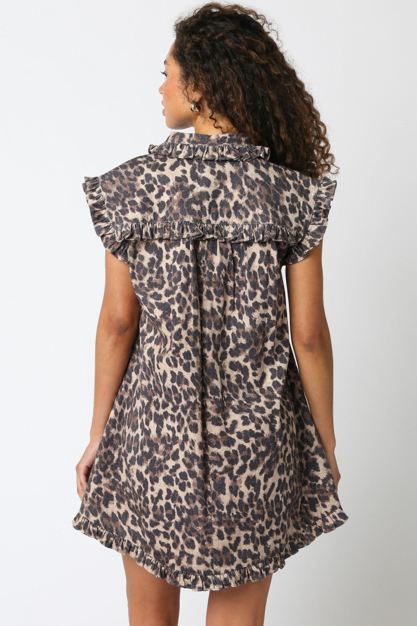 Woman wearing a leopard print dress against a white background