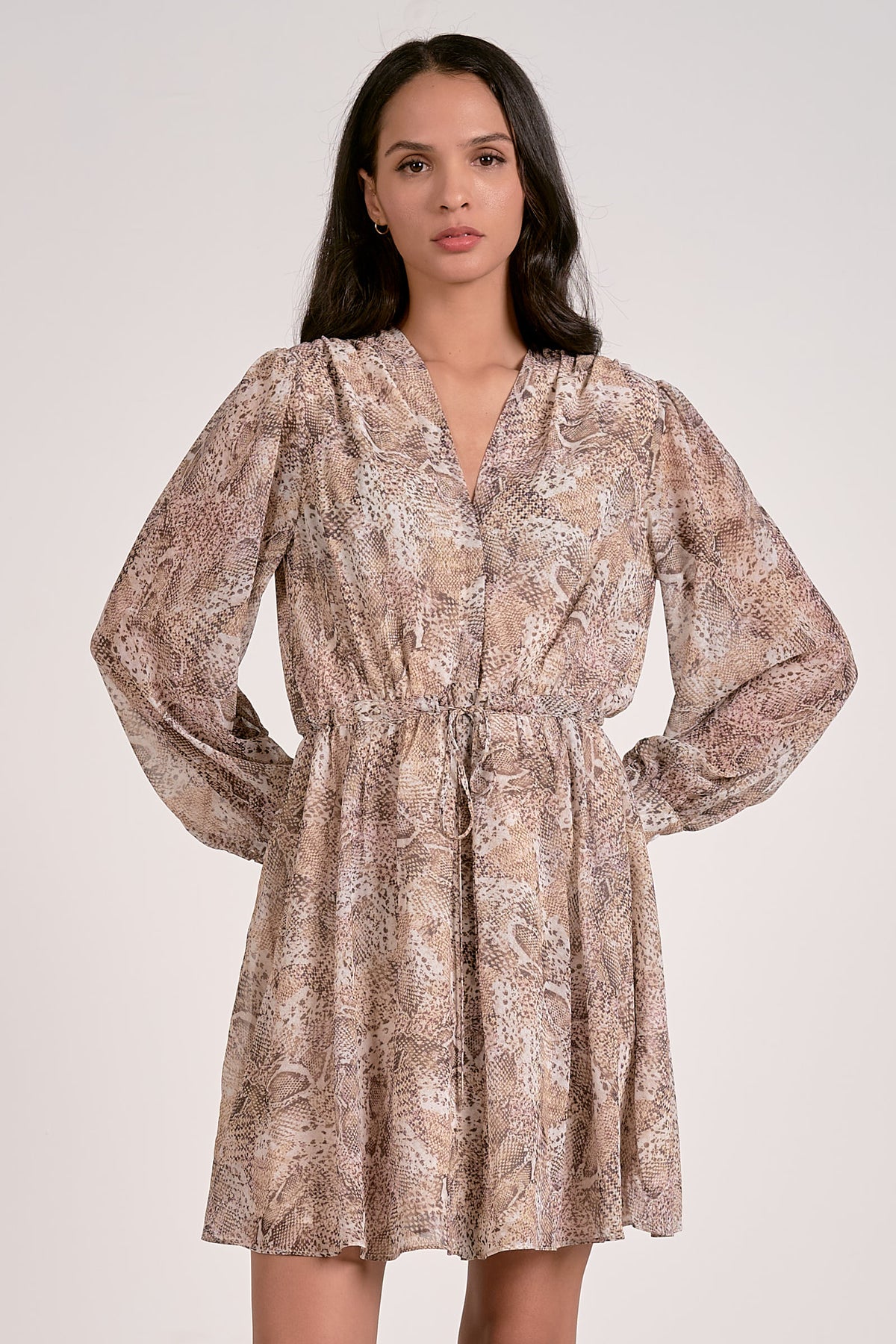 Woman wearing a patterned dress on a white background