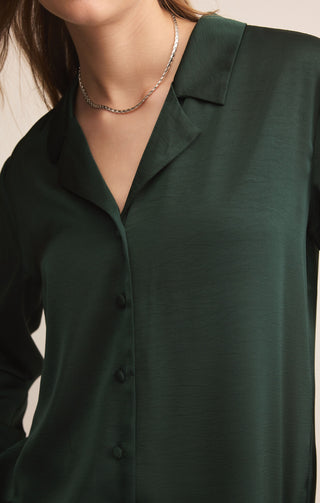 Green shirt worn by a person with a neutral background